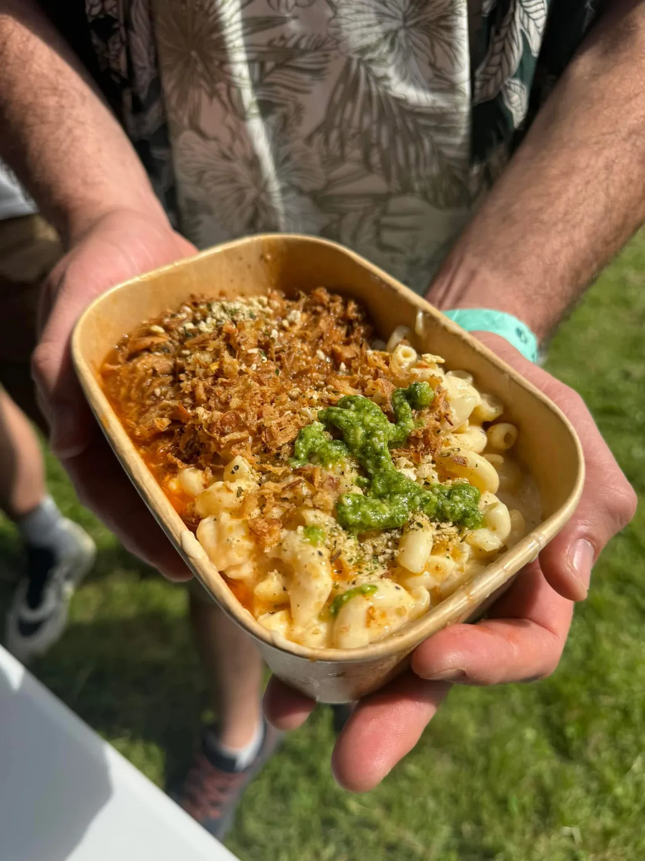 A person holding a bowl with food
